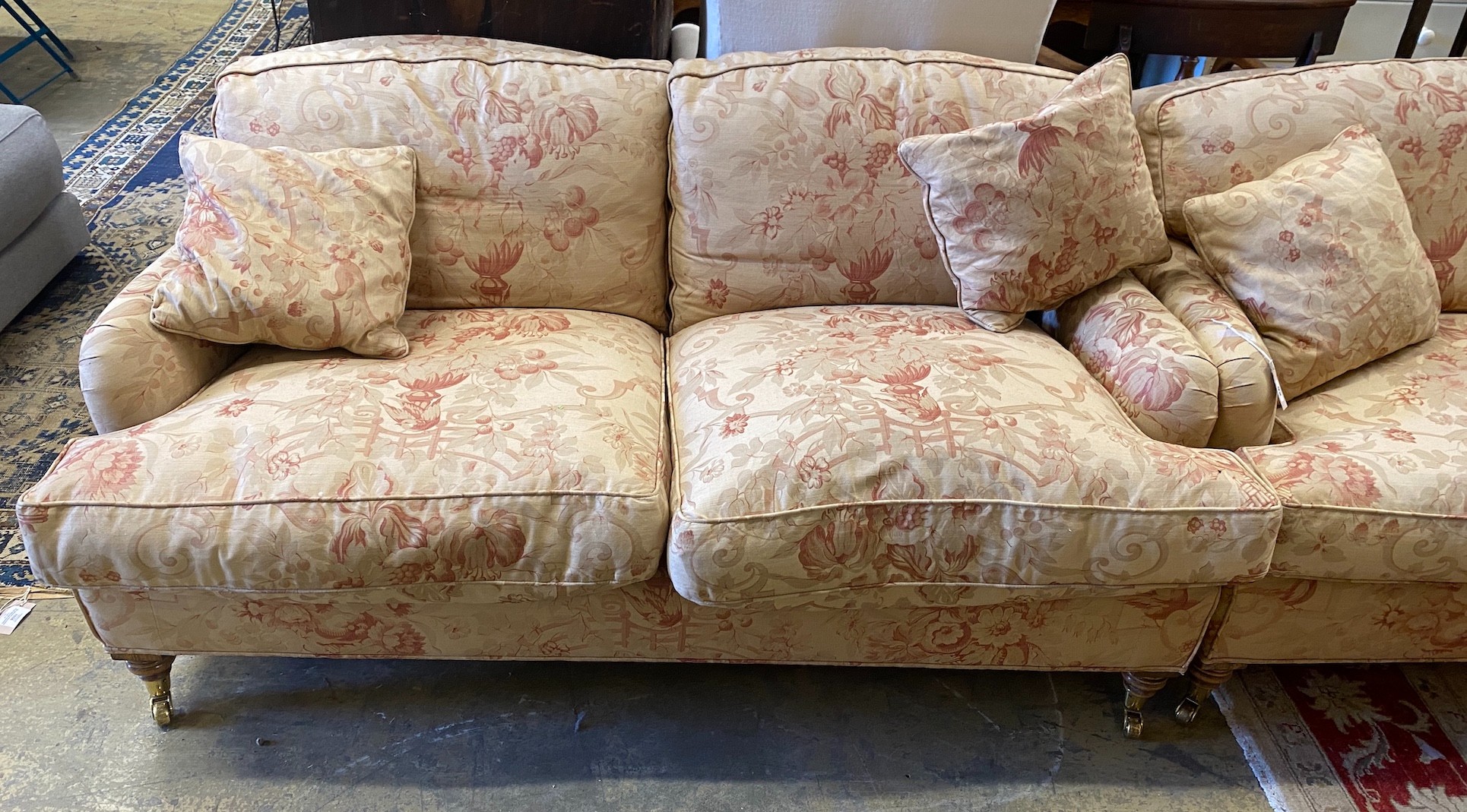 A pair of John Sankey two seater settees with feather cushion seats and backs, length 156cm, depth 82cm, height 75cm